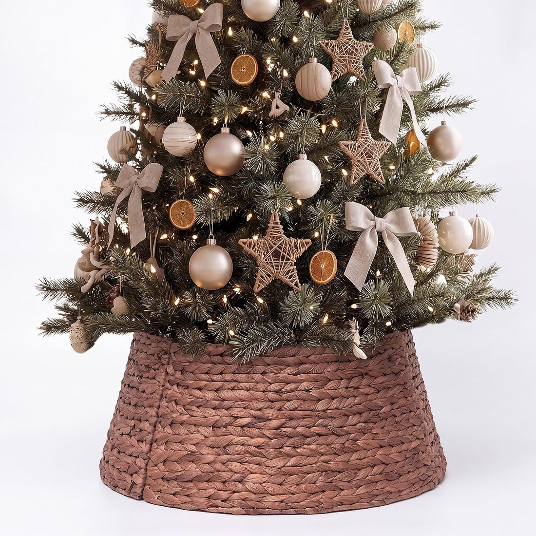 Brown woven water hyacinth collar around the base of a decorated Christmas tree